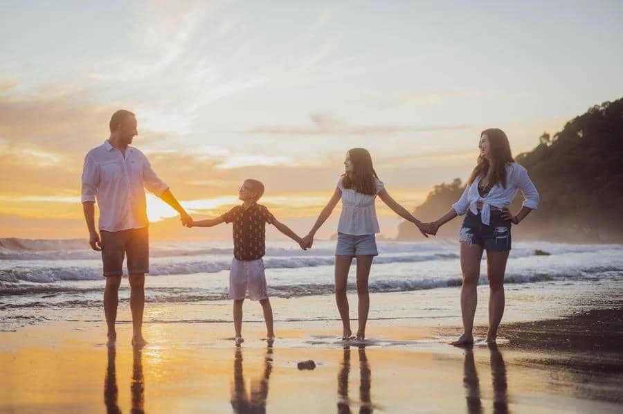 Family of Four Holding Hands on the Beach at Sunset in Jaco – Bookybee – Costa Rica Tours Family of Four Holding Hands on the Beach at Sunset in Jaco – Costa Rica Tours